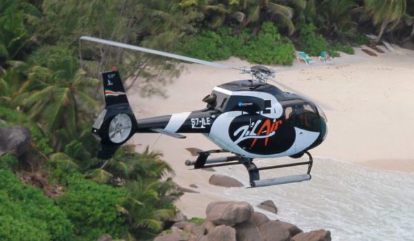 Helicopter flying over beach